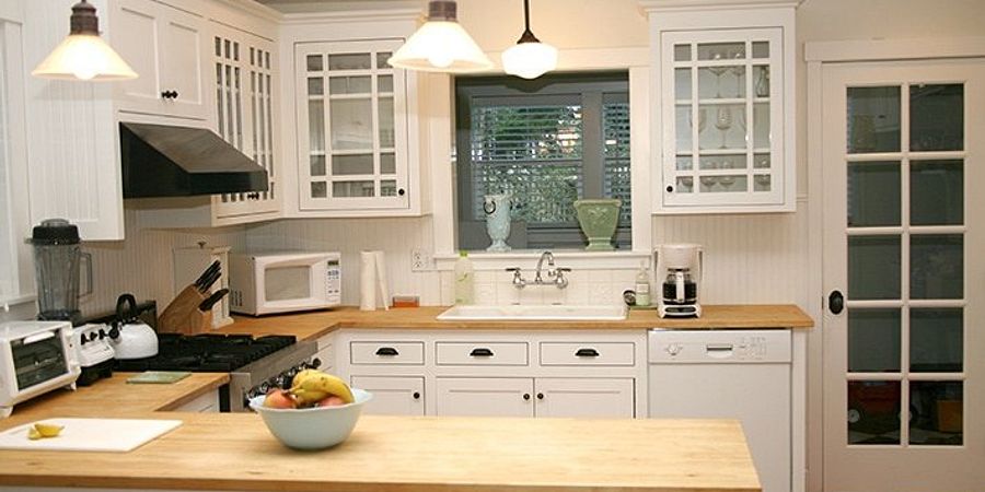 White cabinets with butcher shop block countertops