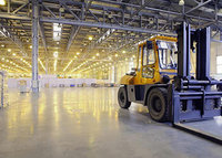 A forklift in a large warehouse